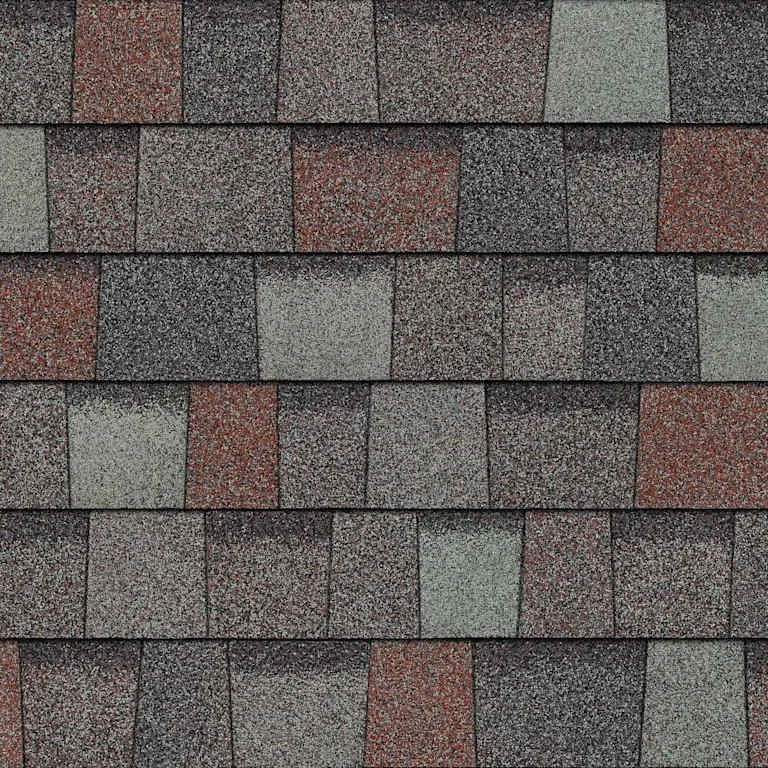 Close-up of a roof with asphalt shingles in gray, black, and red colors.