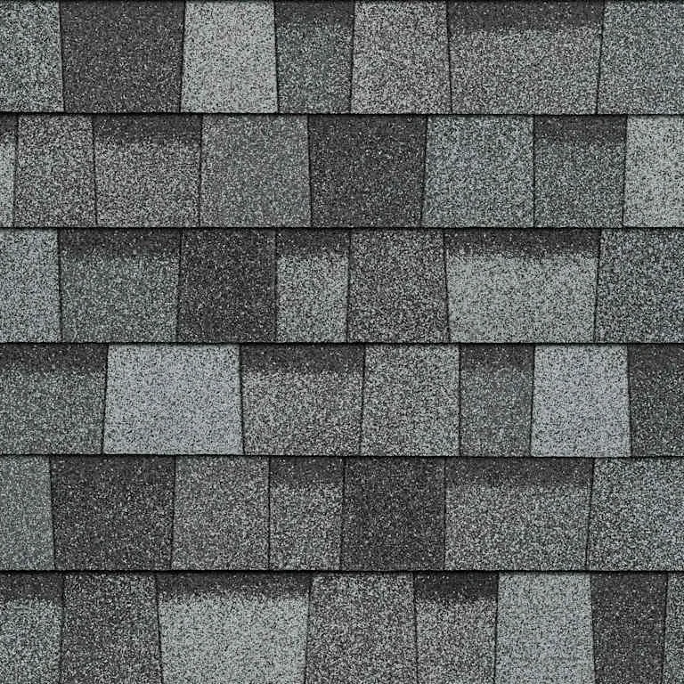 Close-up of gray asphalt shingles on a roof.