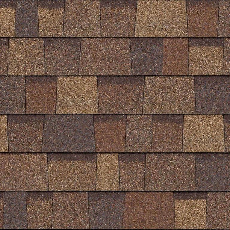 Close-up view of a shingled roof with brown and tan asphalt shingles.