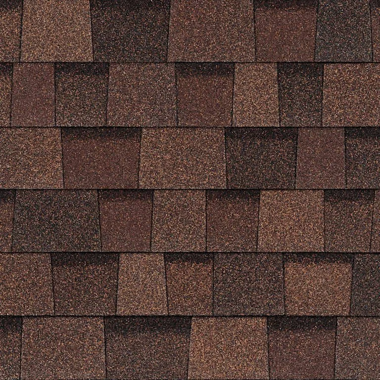 Close-up of a roof with brown asphalt shingles.