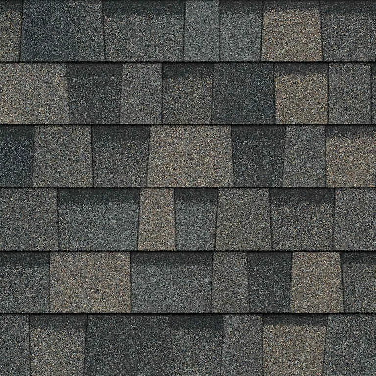 Close-up of asphalt shingles on a roof in gray tones.