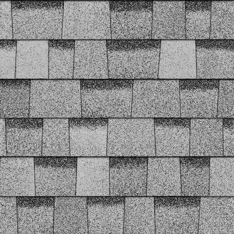 Close-up of a roof with asphalt shingles arranged in a layered pattern.